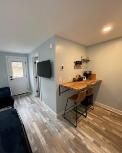 Kitchenette area at the Palisade Lodge featuring modern appliances, coffee setup, and open shelving