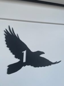 Room number one. Black bird silhouette with the number 1 cut out.